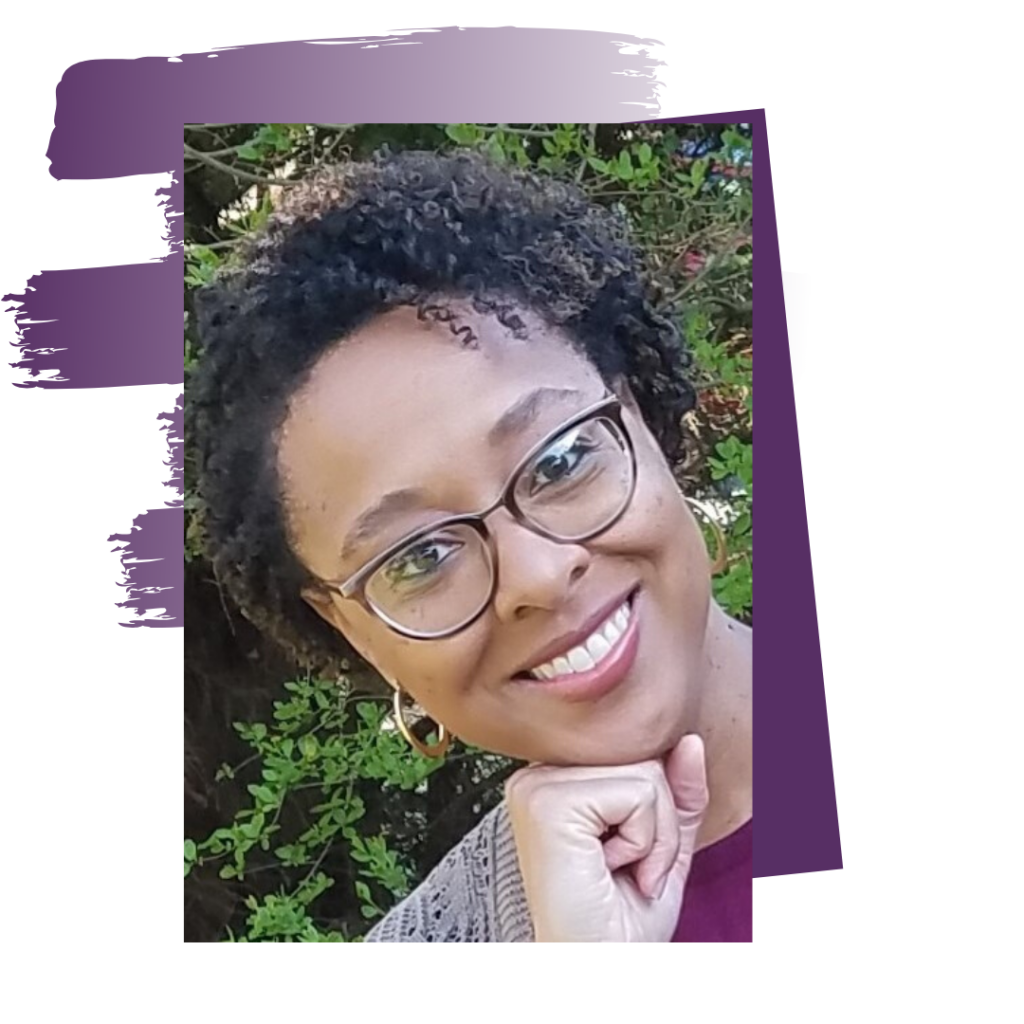 A woman with glasses smiling for the camera.